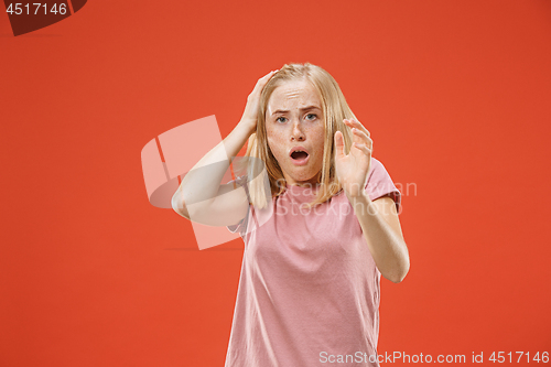 Image of Portrait of the scared woman on red