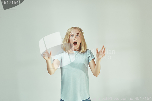 Image of Portrait of the scared woman on gray