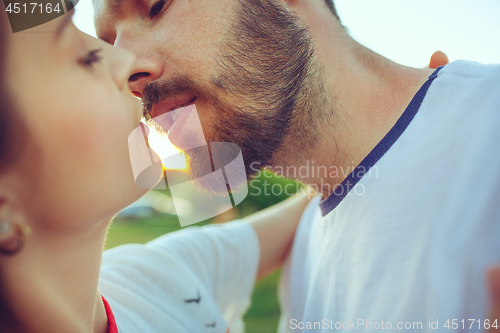 Image of Couple resting on the beach on a summer day near river