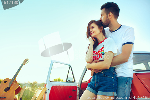 Image of Couple resting on the beach on a summer day near river