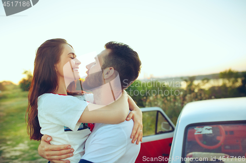 Image of Couple resting on the beach on a summer day near river