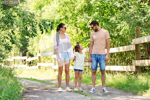 Image of happy family walking in summer park