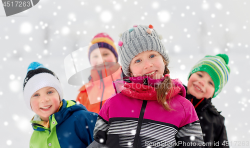 Image of happy little kids in winter clothes outdoors