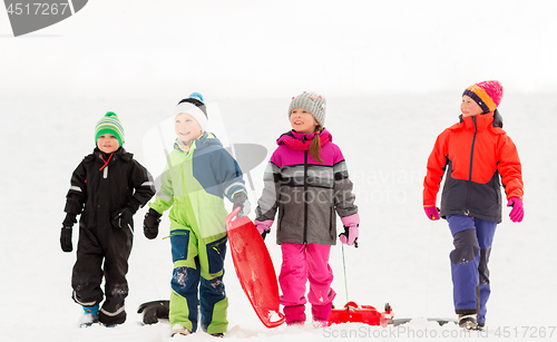 Image of happy little kids with sleds in winter