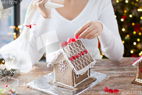 Image of close up of woman making gingerbread house