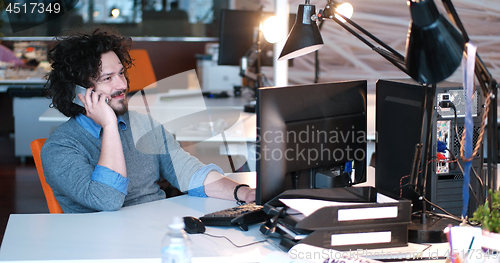 Image of businessman working using a computer in startup office