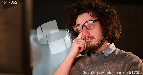 Image of man working on computer in dark office