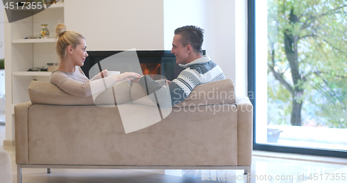 Image of Young couple  in front of fireplace