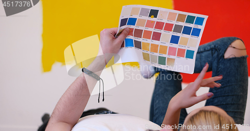 Image of Happy young couple relaxing after painting