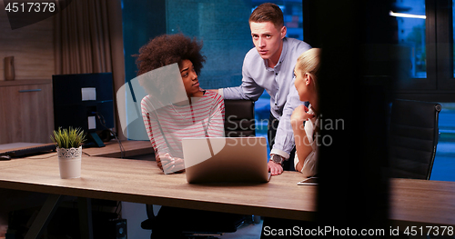 Image of Multiethnic startup business team in night office