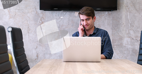 Image of businessman working using a laptop in startup office