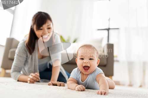 Image of happy little asian baby boy with mother at home