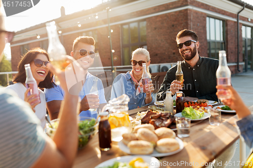 Image of happy friends with drinks or bbq party on rooftop