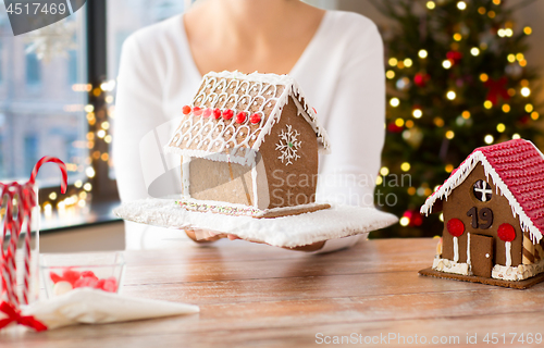 Image of close up of woman with christmas gingerbread house