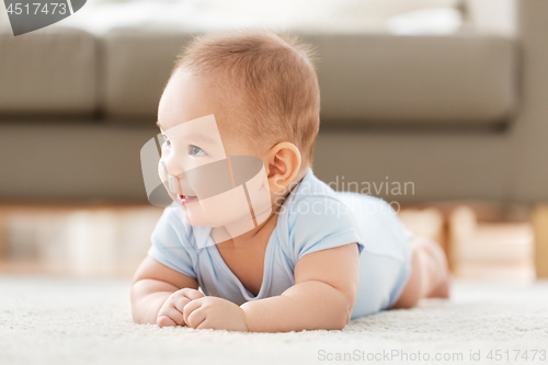 Image of sweet little asian baby boy lying on floor at home