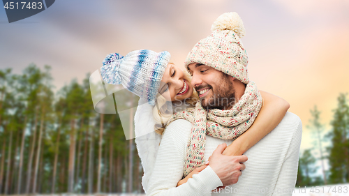 Image of couple hugging over winter forest background