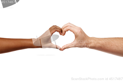 Image of hands of different skin color making heart shape