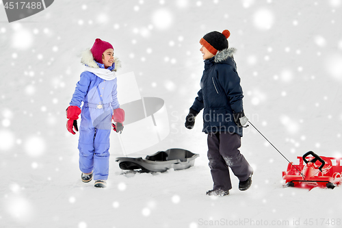 Image of happy little kids with sleds in winter