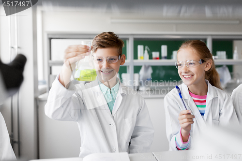 Image of kids with test tubes studying chemistry at school