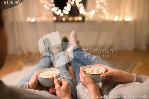 Image of close up of couple drinking hot chocolate at home