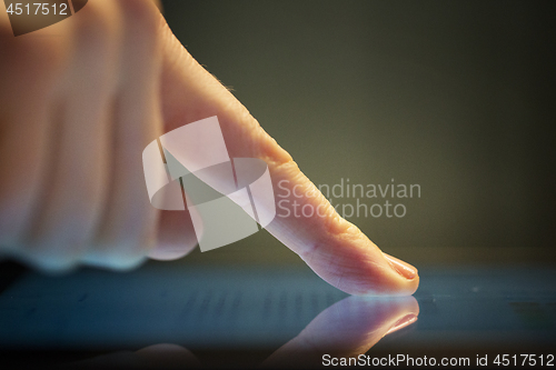 Image of close up of hand using computer touch screen