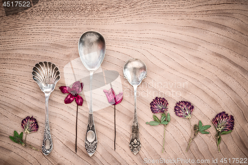 Image of Dried purple flowers and vintage silver spoons