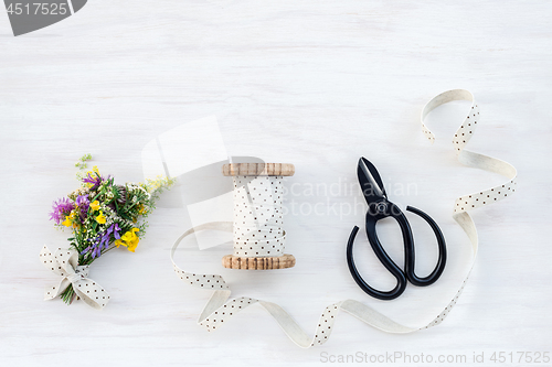 Image of Bouquet of wildflowers with ribbon and scissors