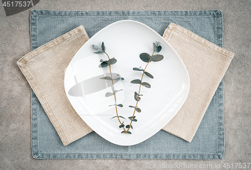 Image of Eucalyptus on a white plate and linen napkins