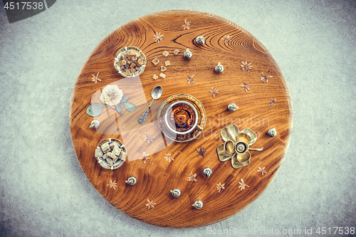 Image of Vintage wooden table with tea and floral decor