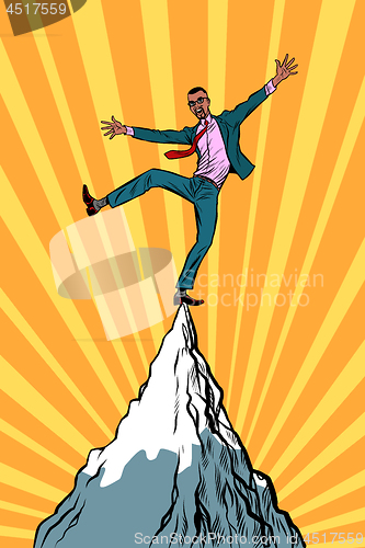Image of african businessman at the top of the mountain