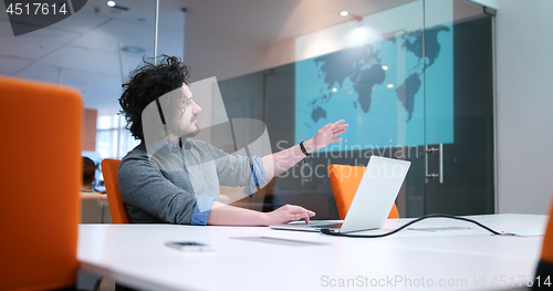 Image of businessman working using a laptop in startup office