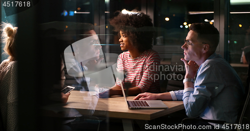 Image of Multiethnic startup business team in night office
