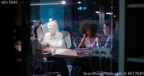Image of Multiethnic startup business team in night office