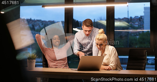 Image of Multiethnic startup business team in night office