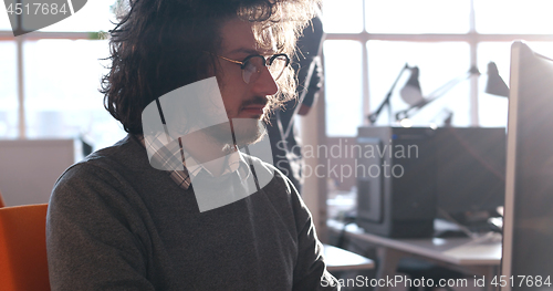 Image of businessman working using a computer in startup office