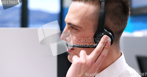 Image of male call centre operator doing his job