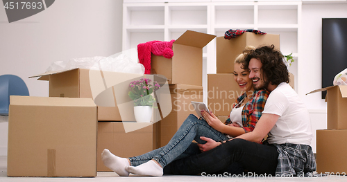 Image of young couple moving  in new house