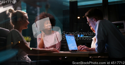 Image of Multiethnic startup business team in night office