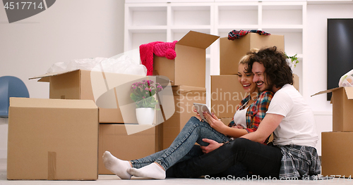 Image of young couple moving  in new house