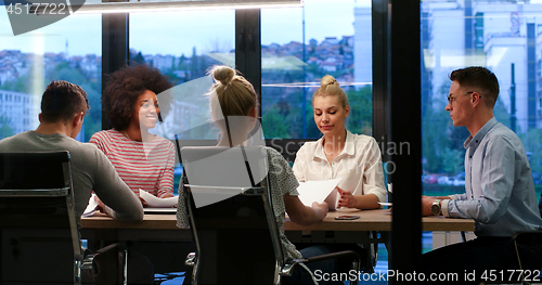 Image of Multiethnic startup business team in night office