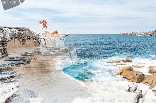 Image of Smiling female, happy days basking in the summer sunshine by the coast