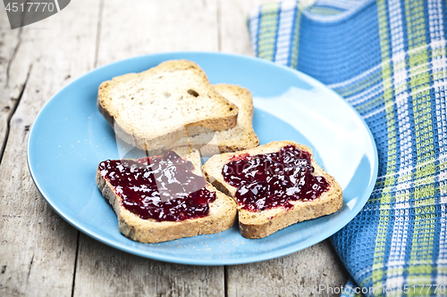 Image of Fresh toasted cereal bread slices with homemade wild berries jam