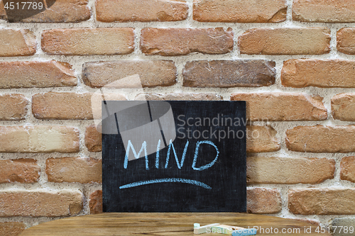 Image of Chalk board with the word MIND drown by hand and chalks on woode