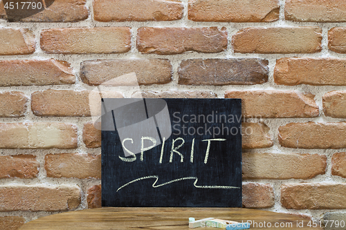 Image of Chalk board with the word SPIRIT drown by hand and chalks on woo