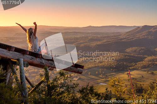 Image of Woman arms outstretched embrace each day