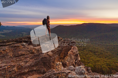 Image of Hiker watching the last light in the mountains