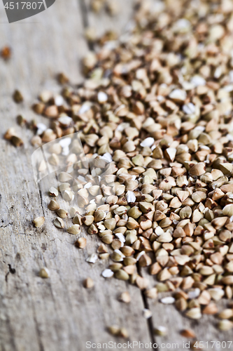 Image of Fresh green dry buckwheat seads closeup on rustic wooden backgro