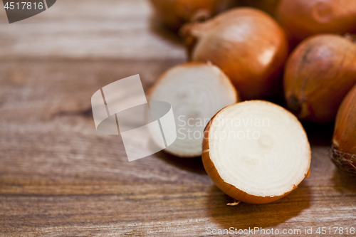 Image of Organic fresh  onions heap closeup on rustic wooden table backgr