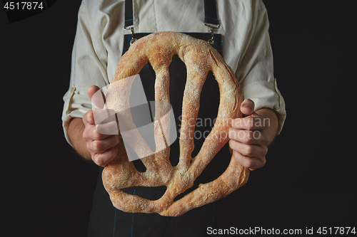 Image of Baker\'s hands hold fougas bread