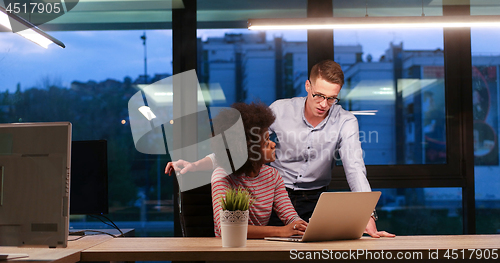 Image of Multiethnic startup business team in night office
